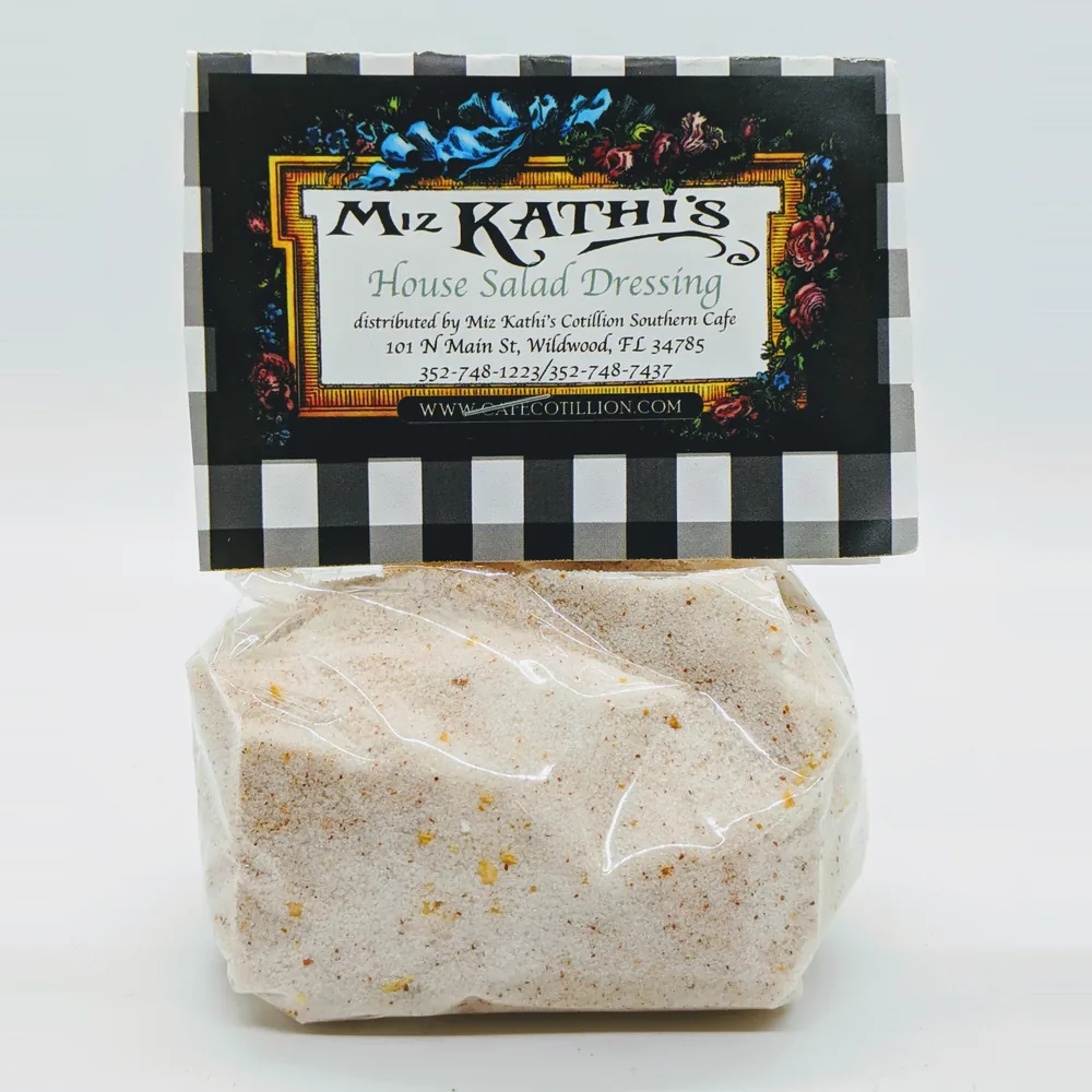A clear bag of Miz Kathi’s House Salad Dressing seasoning mix under a black-and-white gingham label